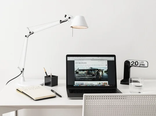 Skrivebordslampen fra Artemide Tolomeo Tavolo i stemningsudsigten: Lampen kan justeres optimalt til arbejdspladsen takket være den fleksible drejearm og den drejelige lampeskærm.